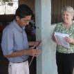 Judy passing out sheets of stickers to teachers